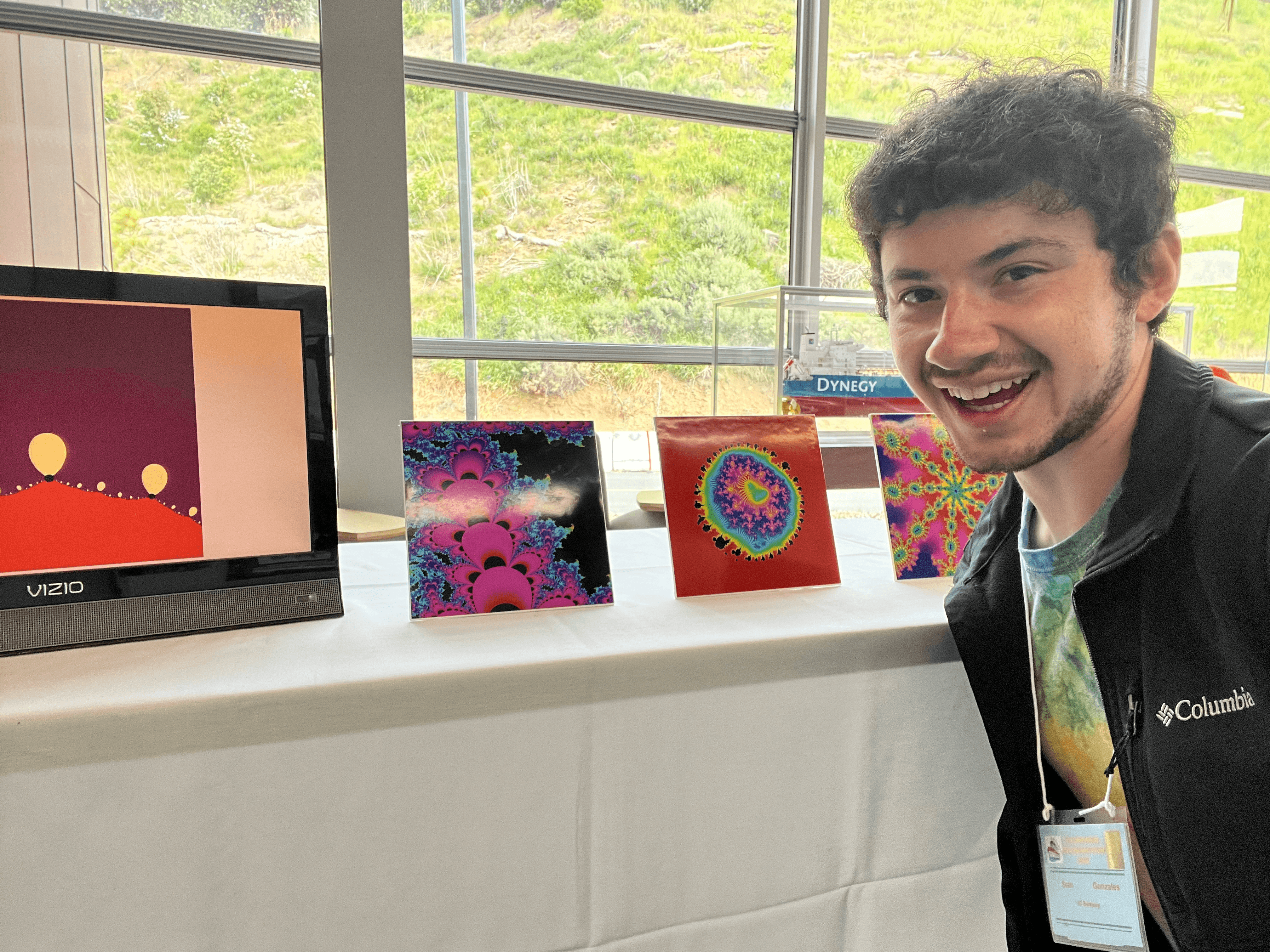 Myself in front of a table displaying some of my computer generated art